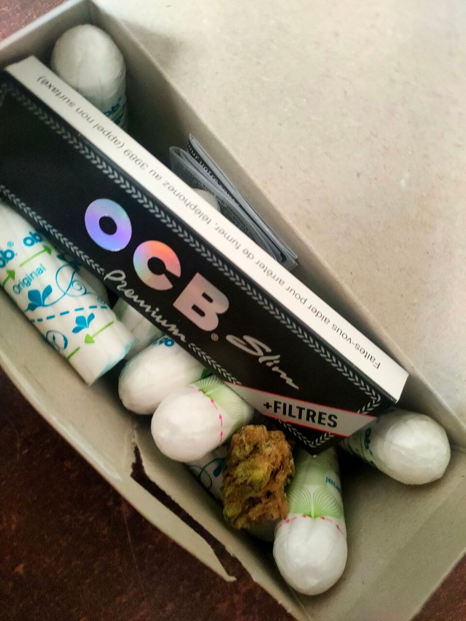 Weed and rolling paper in a box of tampons